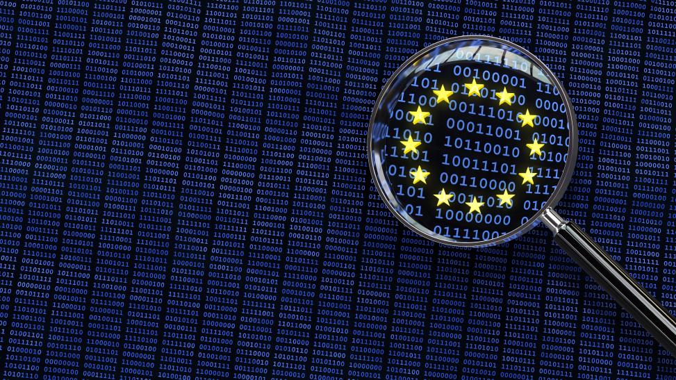 Combinations of numbers of 0 and 1 spotlighted with the European stars to symbolize the focus on the European legislation data protection update magnifying glass over eu data flag