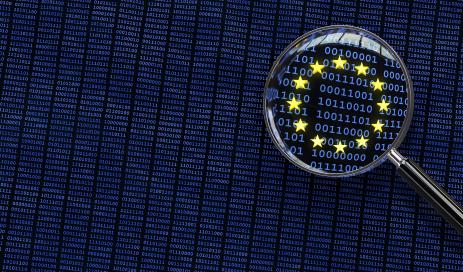 Combinations of numbers of 0 and 1 spotlighted with the European stars to symbolize the focus on the European legislation data protection update magnifying glass over eu data flag