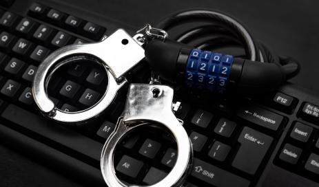 Directors liability data-protection Directors risk personal liability and locked handcuffs which lie on a keyboard of this picture if they do not comply with data privacy regulation.