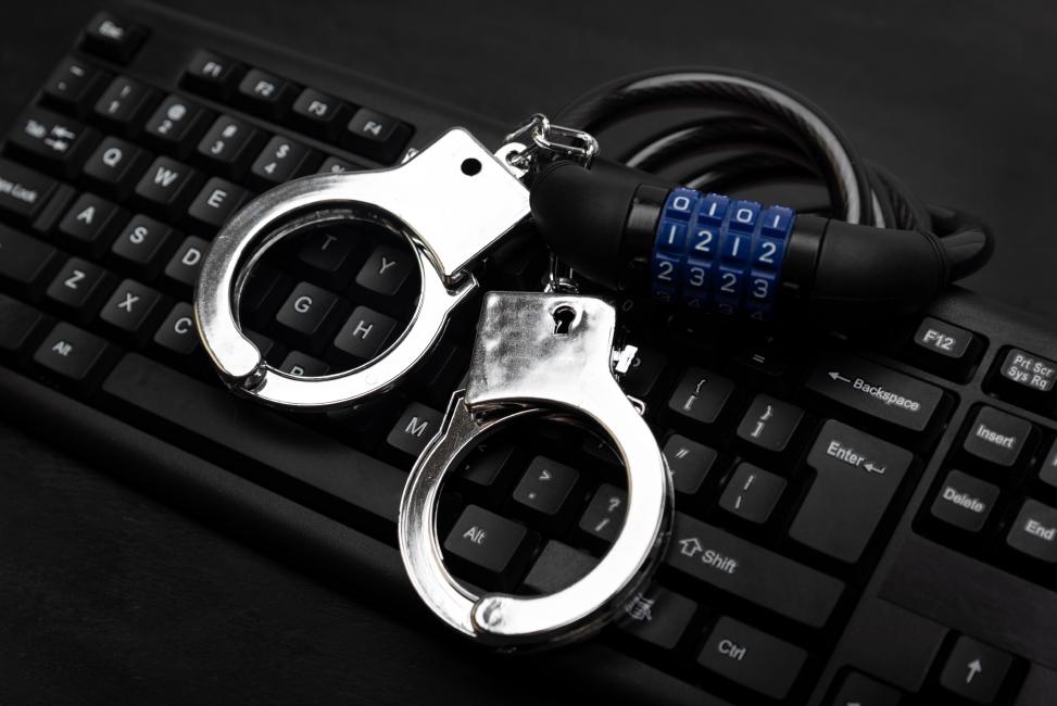 Directors liability data-protection Directors risk personal liability and locked handcuffs which lie on a keyboard of this picture if they do not comply with data privacy regulation.