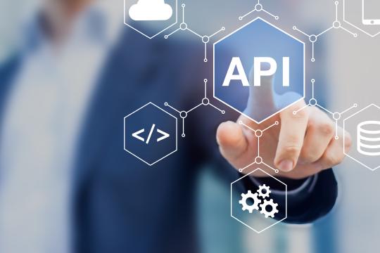 Businessman clicking on a virtual concept screen with an API (Application Programming Interface) node in the middle connecting server, Internet, smartphone and cloud computing (icons).