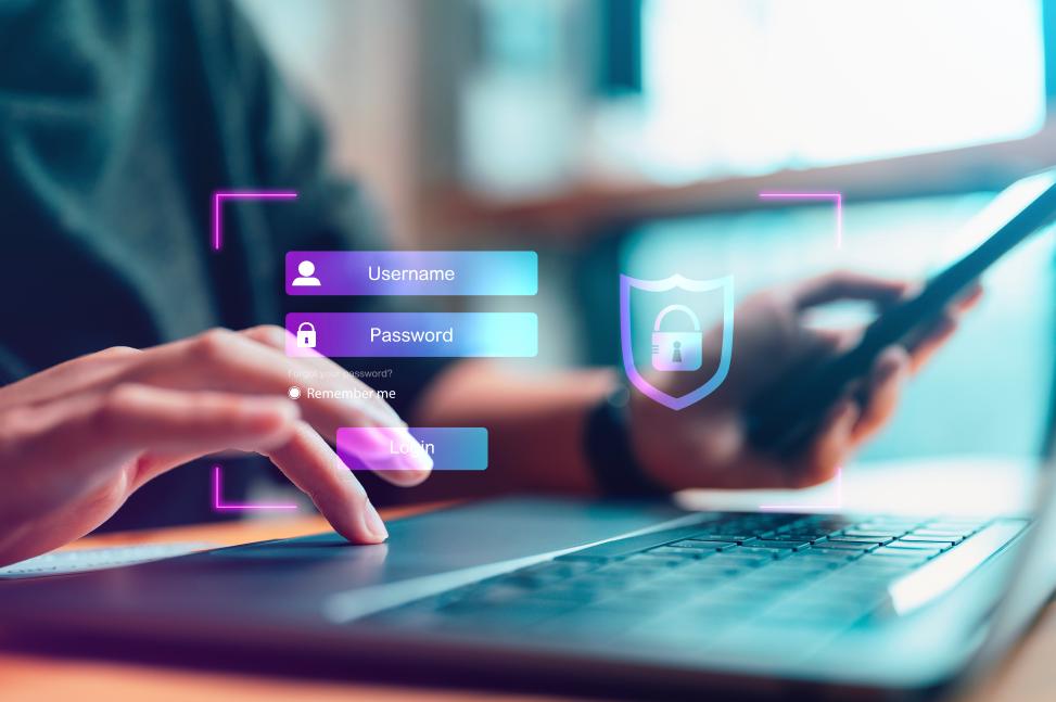 Passwort-Authentifizierung Anwender sitzt vor einem Notebook und gibt seinen Benutzernamen und sein Passwort auf einem virtuellen Anmeldebildschirm ein.