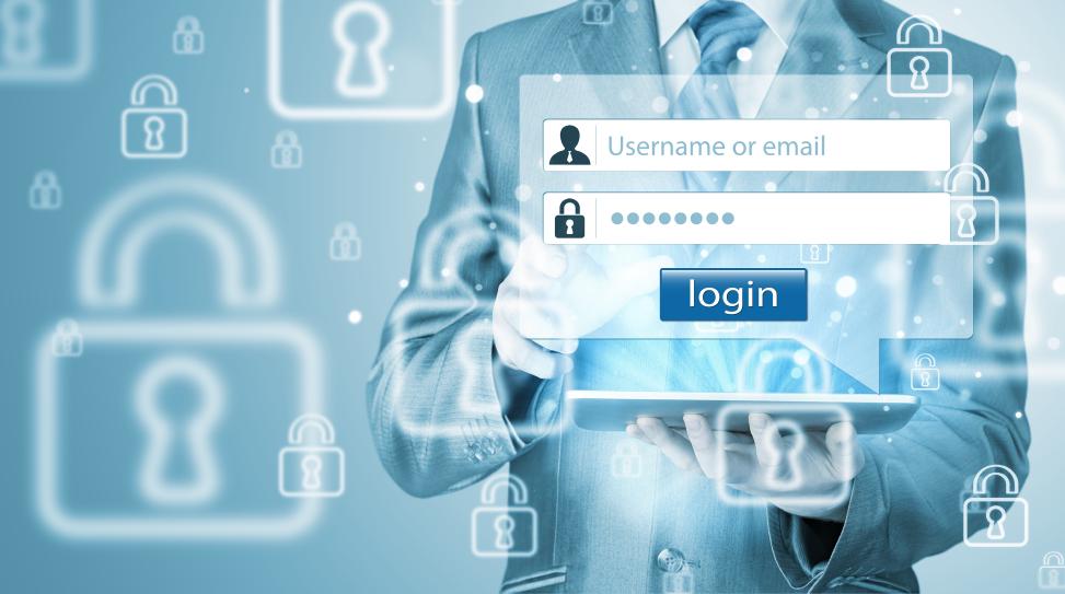 Businessman holding a tablet device and entering login credentials and standing in front of a wallpaper with many locks symbolizing a secure authentication process.
