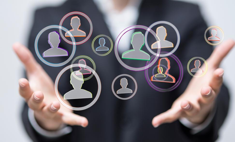 Die Notwendigkeit eines Identitäts- und Zugriffsmanagementsystems wird durch zwei Hände verkörpert, die Identitäten in Form von Kreisen mit anonymen Personen darin halten.